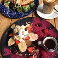 Fruit pancakes (bottom), vacon bagel (top), and almond milk latte at Gathered Kitchen in Glebe