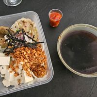 Takeaway vegan dumplings soup (14.2€), you pour the liquid into the box with ingredients. Noodles not visible on the bottom. Chili for spiciness. at Tokyo Street in Helsinki