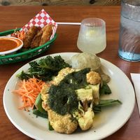 Cauliflower Steak, Not-zerella Sticks, pineapple mocktail, and a water. at Green Vegetarian Cuisine - Quarry Market in San Antonio