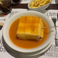Lovely francesinha with vegan cheese, vegan tofu, vegan sausage, and a vegan alcohol gravy  at Lado B Cafe in Porto