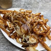 Vegan Poutine with fried onions at La Banquise in Montreal