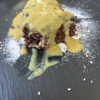 Chocolate onigiri covered in delicious orangy sauce   at Vegan Yes in East London