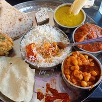 This is the Thali for 1 at £9.99. Includes a small sweet, but make sure you tell them you're vegan.  You can choose 2 mains from the specials and the rest is set. at Mithaas in Leicester