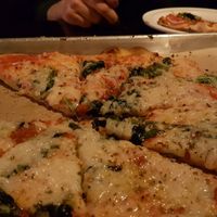 Spinach & onion pizza with vegan cheese at Need Pizza in Cedar Rapids