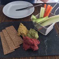 A selection of homemade beetroot, avocado and mixed bean hummus  at Raizes in Quarteira