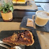 Loved the deserts! Mango Cheesecake and Snickers tart. at Raizes in Quarteira