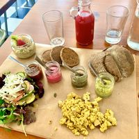 Brunch of champions! One meal = Tofu scramble, warm bread with avocado spread, pancakes and chocolate sauce, chia banana pudding, Side salad 🥗, beet juice mixture & a coffee! at GiG - Green is Good in Ericeira