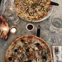 The bottom pizza is the Vegan Giardana (idk how to spell it) approx £17/18 and the top one is a vegetarian margarita with mushrooms added approx £16  at Pizza Express - Corn Exchange in Manchester