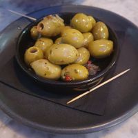 Marinated Green Olives: with pink peppercorns and whole sweet garlic cloves at Pizza Express - Trafford Centre in Manchester