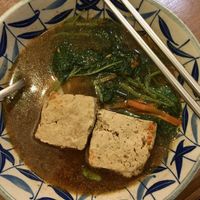 Braised stinky tofu with oil noodles. Comes with basil leaves and greens. I asked for it to be extra spicy.  at Qiao Ben Wei in Chihshang
