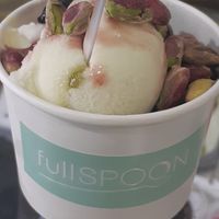 Lime sorbet and coconut ginger ice cream topped with black cherries and pistachios at Full Spoon in Athens