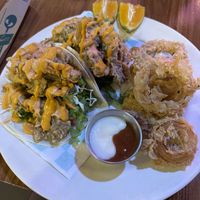 Fish Tacos made with oyster mushrooms with onion rings - nice and crunchy   at Huacamole Vegan Food in San Pedro