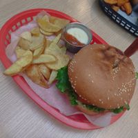 Chicken burger with potato wedges and dip at Huacamole Vegan Food in San Pedro