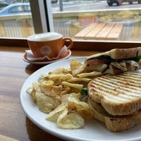 Vegan ‘Chik’n’ Avocado meat-free ‘chik’n’ patty, spinach, tomato, avocado & balsamic glaze on panini-pressed turano bread. Almond Milk Flat White at Java Surf Cafe & Espresso Bar in Virginia Beach
