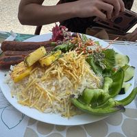 Homemade chorizo style seitan sausages with grilled pineapple, rice and salad at Veggie Momi in Albufeira