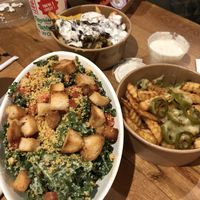 Kale Caesar salad with nutritional yeast parmesan, and fries smothered in cheese and stuff. Yum! at Next Level Burger - Roosevelt in Seattle