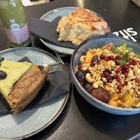 Brunch time - soy yoghurt bowl topped with fruits and granola, slice of pistachio cake and green smoothie  at Ready in Luxembourg City