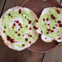 Crunchy tostadas with sesame paste and guac, I sprinkled on some red sauce :) at Schizandra in Oaxaca