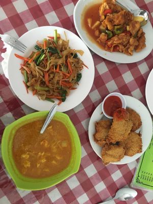 Chicken curry, kentucky, fried noddles and sweet sour chicken at Happy Buddha in Kuta