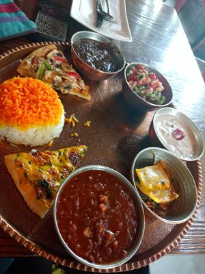 Mixed traditionell iranien food plate with beans, salad, soyjoghurt, rice, salad, Fesendjan, lasagna, pizaa at Iranian Artist's Forum - Khaneh Honarmandan Iran in Tehran