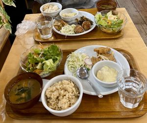 Set meal including miso soup, salad, rice, coleslaw, creamy potatoes, and kuruma fu (Japanese wheat gluten disk) with onions. at Crayon House in Tokyo