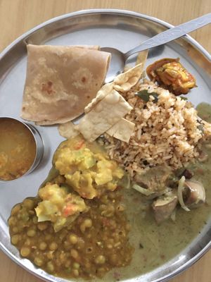 Sesame rice, chapati, green pea dhal, potato subzi, rasam and brinjal curry with papadam chips.  at Annalakshmi Temple of Fine Arts in Penang