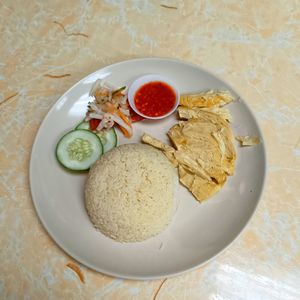 'Chicken rice' with soy bean curd skin made to look like steamed chicken with pickled vegetables and cucumber.

I like that the rice wasn't oily at all. at Ci Hang 慈航 in Central Singapore
