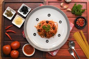 Spaghetti Puttanesca (Tomato sauce, olives, capers, chili, oregano) at Govinda Italian Restaurant & Pizzeria in Bangkok