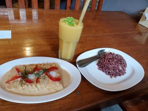 Tofu in curry sauce, brown rice, and soy milk mango lassi. at Aum in Chiang Mai