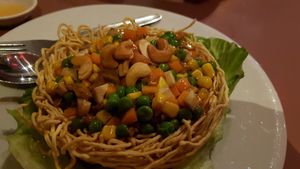 Cashews and cubed vege on crispy noodles bowl at Mother Chu's Vegetarian Kitchen in Sydney