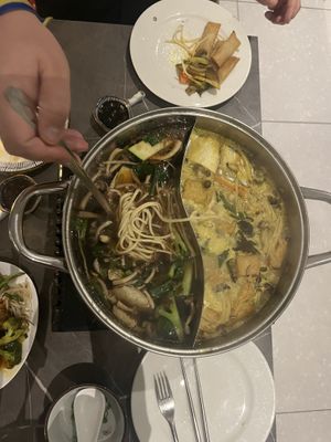 the hot pot: vegetable broth in one half, curry soup in the other  at Vegetasia in Vienna
