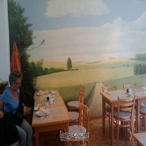 The cafe is decorated very simply with peaceful wall murals at Den Teepot in Brussels