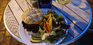 Moroccan burger with side salad and white wine at Wai Kika Moo Kau in Brighton