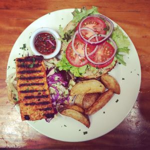 Tempeh burger with chunky wedges and salad at Alley Cafe Bar in Nottingham