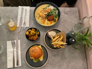 Burger with fries and baled potatoes as well as some delicious curry at Mildreds - Soho in London