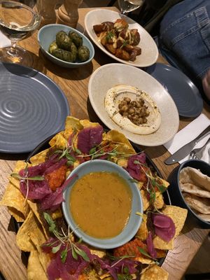 Range of small plates including; nachos, olives, patatas bravas and hummus.   at Mildreds - Soho in London