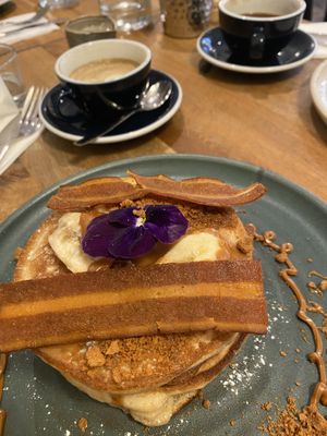 Banana pancakes with rashers and oat milk latte  at Mildreds - Soho in London