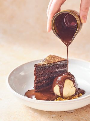 Chocolate ganache layer cake with salted caramel ice cream and chocolate sauce at Mildreds - Soho in London