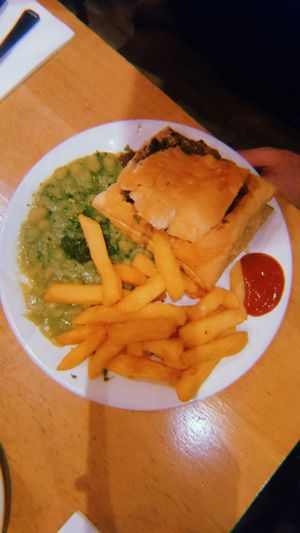 Wood roasted mushrooms and ale pie with minted mushy peas and fries  at Mildreds - Soho in London