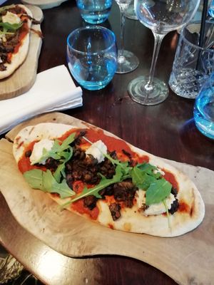 Flatbread with tomato sauce, hummus, paprika mushrooms and crispy capers at Greens in Manchester