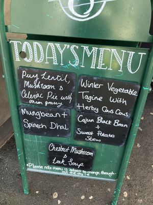 Board outside   at The 8th Day in Manchester