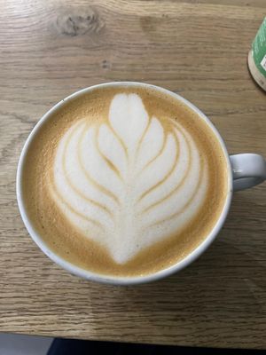 Oat milk latte at The 8th Day in Manchester