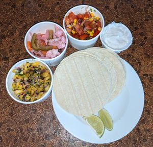 Mexican menu home delivery. Pineapple and jalepeno salsa, escabeche (Mexican pickles), toasted corn pico de galo, and vegan sour cream at Blue Moon Cafe in Sheffield