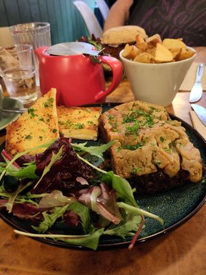 Shiitake mushroom lasagne, potato wedges and fennel tea. at Herbies in Exeter