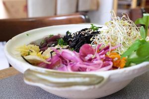 Bowl served in the restaurant: two cereals, one legume, pickels, vegetables at Grand Appetit in Paris
