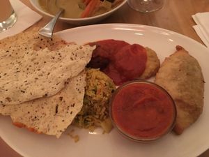Thali - it’s a lot of food including a little dessert (hiding under poppadum) at Prinz Myshkin City in Munich