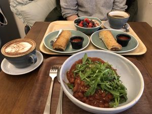 Beans, hot choclate, sausage roll, overnight oats with berry, wallnuts, seeds and syrup   at Cornucopia in Dublin