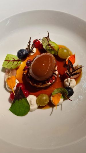 Uovo di gianduja, biscotto di miglio, semi e cioccolato, spuma di cocco e frutti di bosco, salsa di caffè at Joia Alta Cucina Naturale in Milan