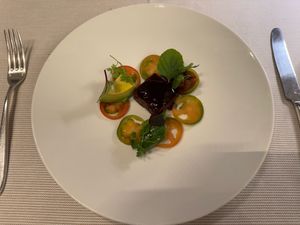 "Spring Swallows" — Housemade lentil-pumpkin seed tempeh with marinated avocado, agedashi eggplant, and zucchini at Joia Alta Cucina Naturale in Milan