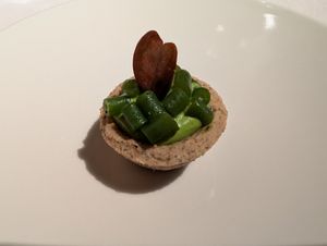 Pre-course buckwheat tartlet with green mousse and beans at Joia Alta Cucina Naturale in Milan